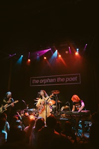 the orphan the post on stage at a concert