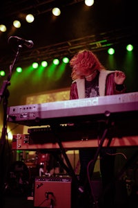 a person playing a keyboard on stage