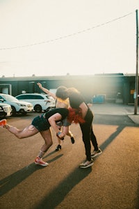 a group of people on a skateboard in a parking lot